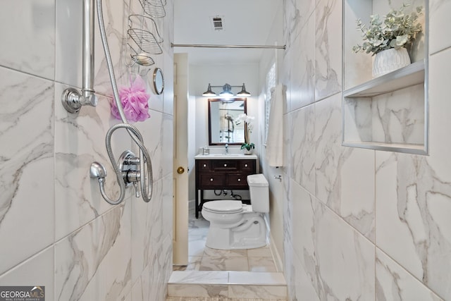 bathroom featuring tile walls, walk in shower, and vanity