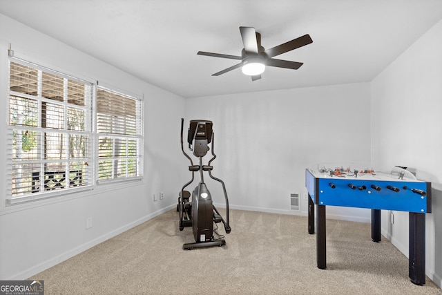 interior space featuring ceiling fan and light colored carpet