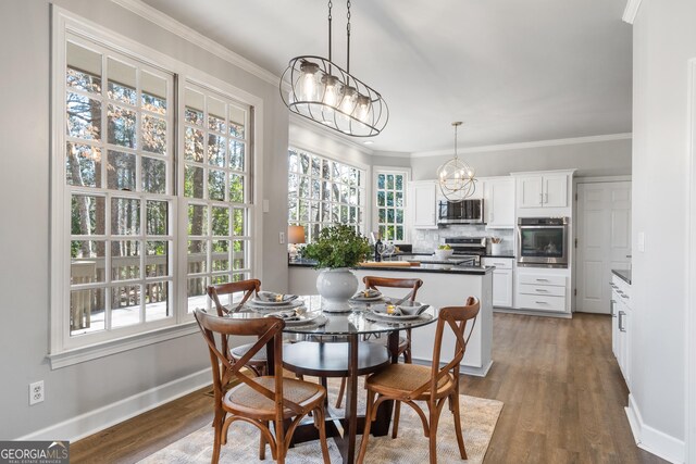 kitchen featuring stainless steel appliances, white cabinets, decorative backsplash, light stone countertops, and crown molding