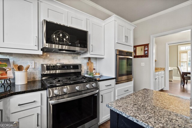 kitchen featuring white cabinetry, dark stone countertops, stainless steel refrigerator with ice dispenser, a kitchen island, and dark hardwood / wood-style flooring