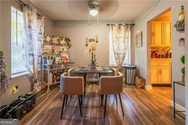 dining space with hardwood / wood-style flooring and ceiling fan