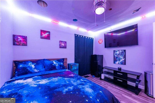 bedroom with ceiling fan and light wood-type flooring