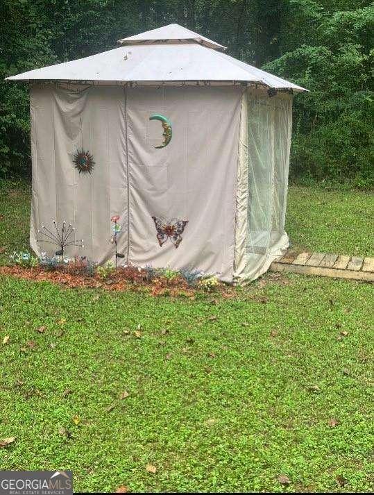 view of outbuilding featuring a yard