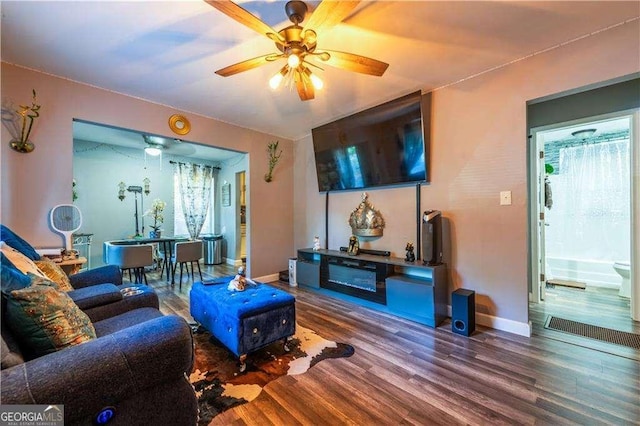 living room featuring ceiling fan and wood-type flooring