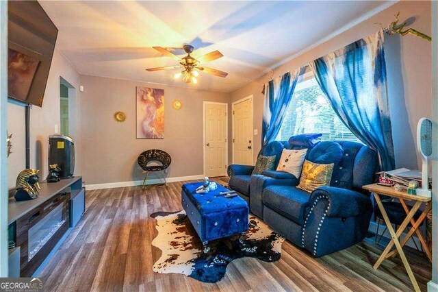 living room with hardwood / wood-style floors and ceiling fan