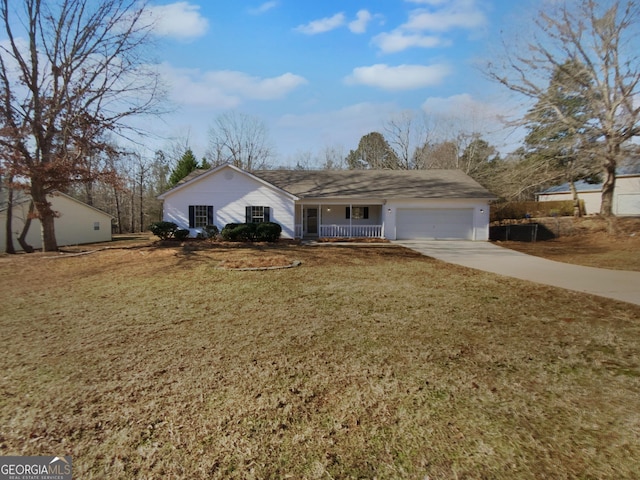 single story home with covered porch, a garage, and a front yard