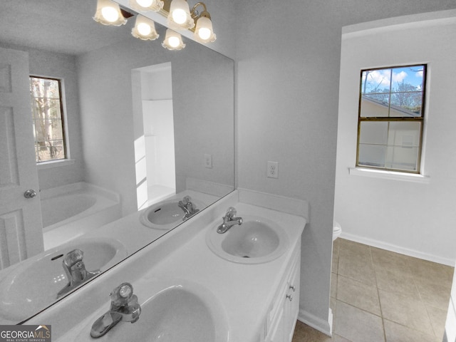 bathroom featuring tile patterned flooring, vanity, and toilet