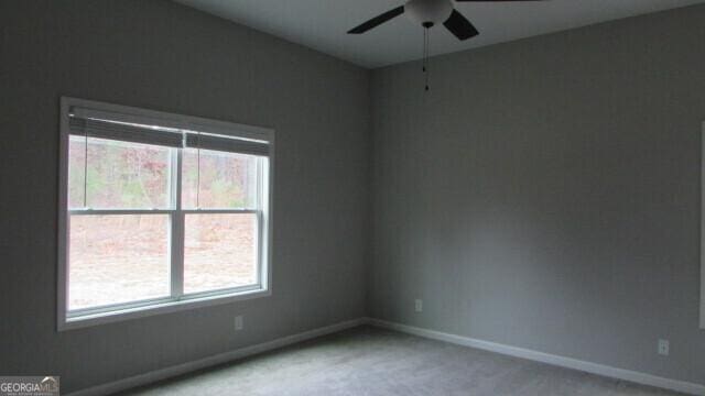 carpeted empty room with ceiling fan