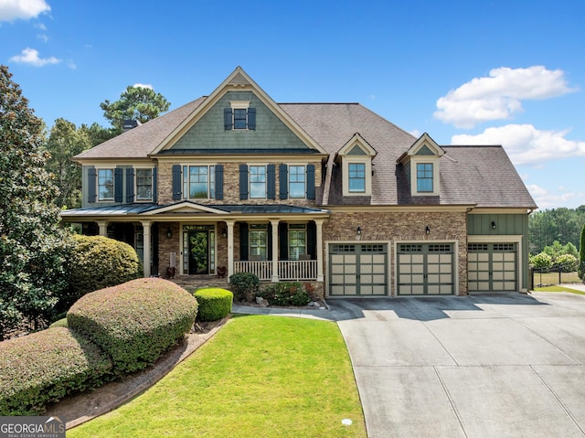 craftsman house featuring a porch, a garage, and a front yard