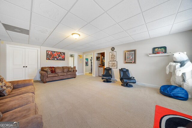 living room with carpet flooring and a drop ceiling