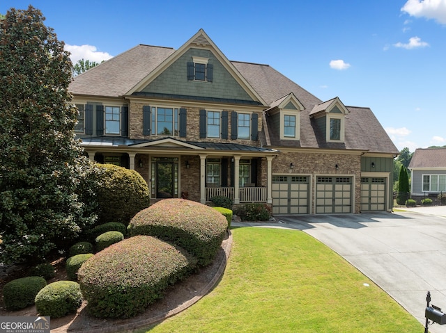 craftsman-style house featuring a porch and a garage