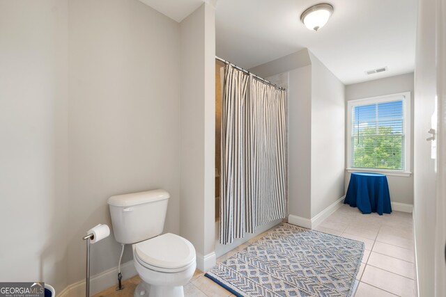 bathroom with tile patterned flooring and toilet