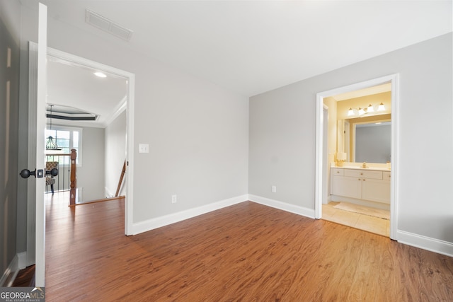 spare room featuring hardwood / wood-style floors and sink