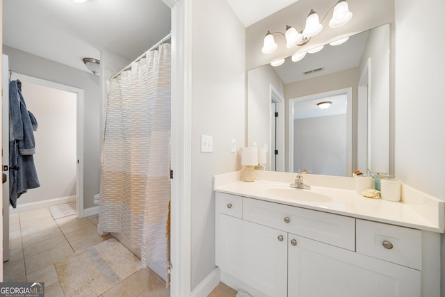 bathroom with tile patterned flooring and vanity