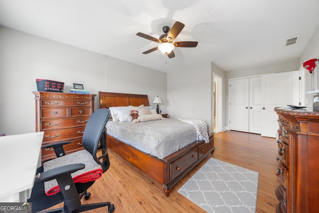 bedroom featuring hardwood / wood-style flooring, ceiling fan, and a closet