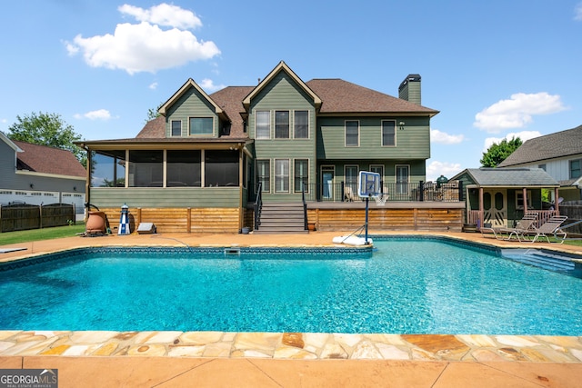 view of pool featuring a sunroom and a patio area