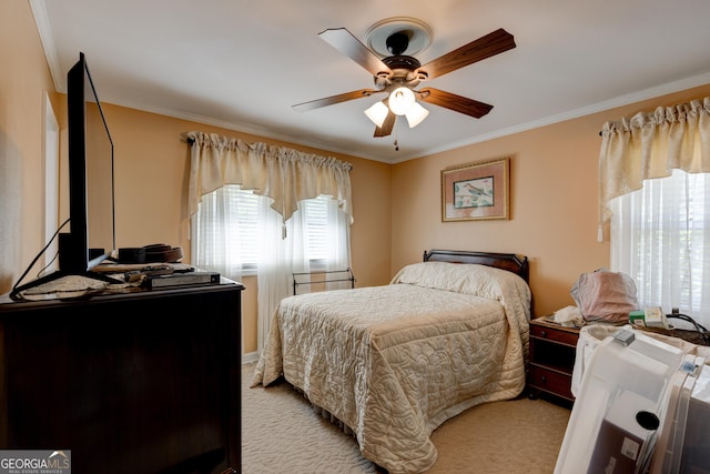 carpeted bedroom with ceiling fan and crown molding