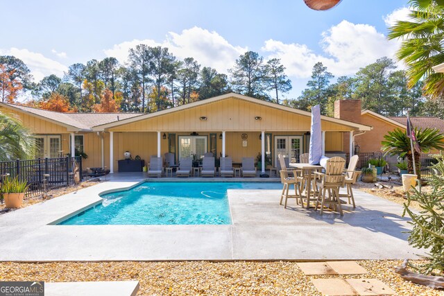 view of pool featuring ceiling fan and a patio