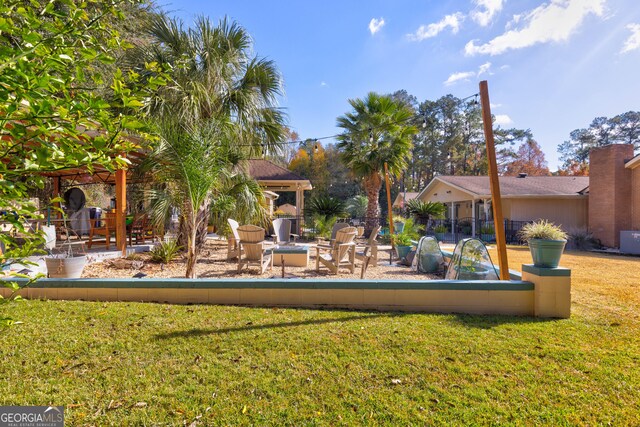 view of yard featuring a patio area and an outdoor fire pit