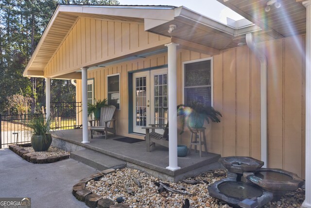 exterior space with covered porch and french doors