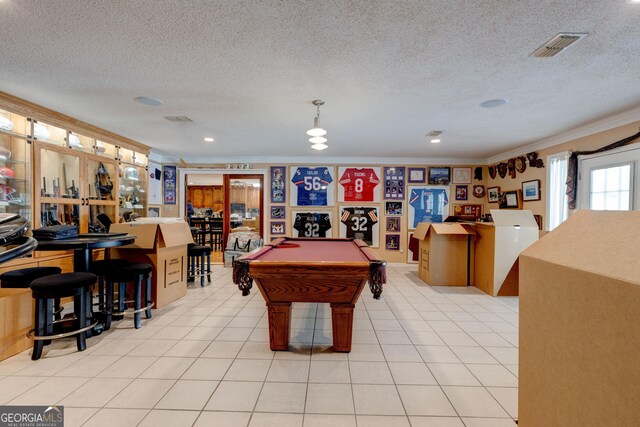 recreation room with light tile patterned floors, a textured ceiling, crown molding, and pool table