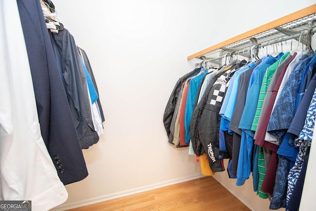 spacious closet featuring hardwood / wood-style floors