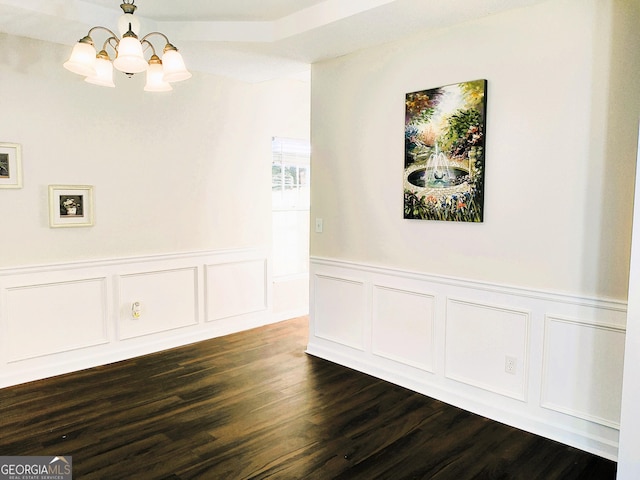 unfurnished dining area with dark hardwood / wood-style flooring and a chandelier