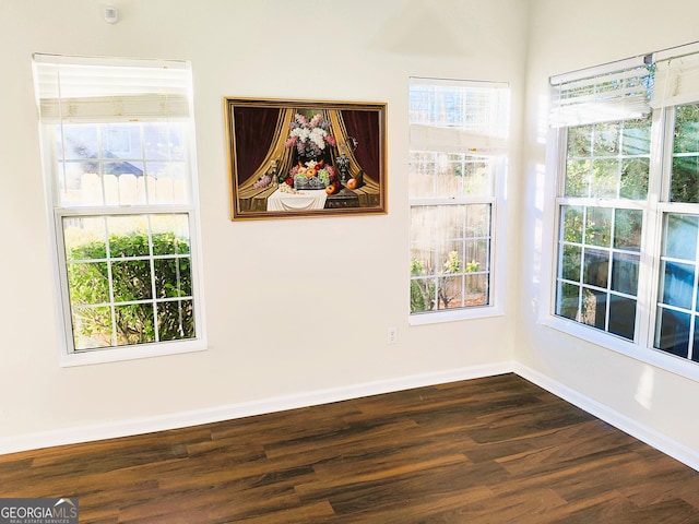 spare room with dark hardwood / wood-style floors