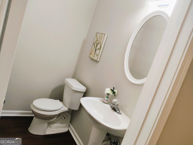 bathroom with sink, wood-type flooring, and toilet