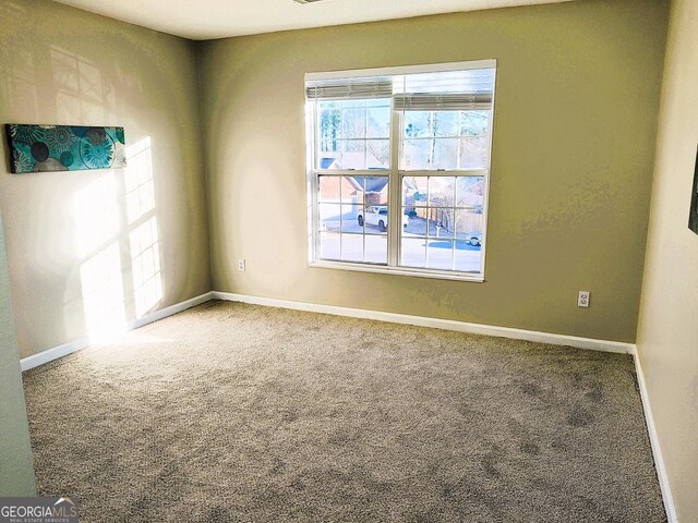 unfurnished room featuring carpet