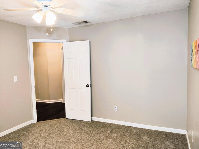 unfurnished bedroom featuring ceiling fan and carpet floors