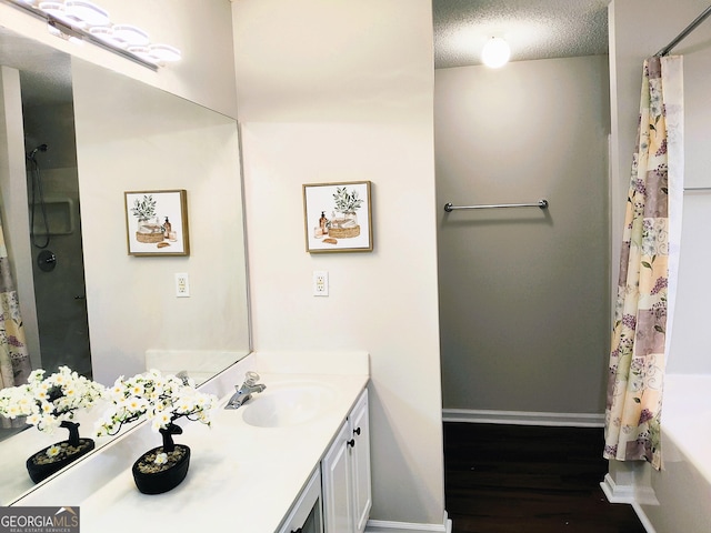 bathroom with a shower with curtain, vanity, a textured ceiling, and hardwood / wood-style flooring