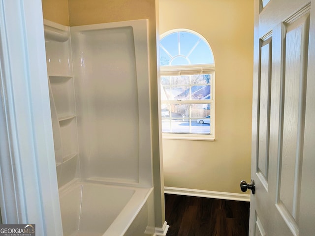 bathroom featuring shower / washtub combination and wood-type flooring