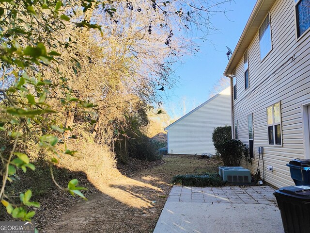 view of yard featuring a patio area and central AC