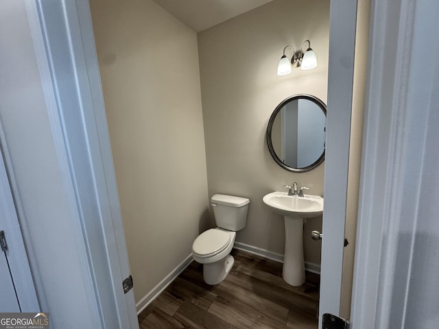 bathroom featuring hardwood / wood-style floors, toilet, and sink