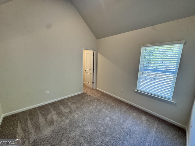 unfurnished bedroom with carpet and high vaulted ceiling