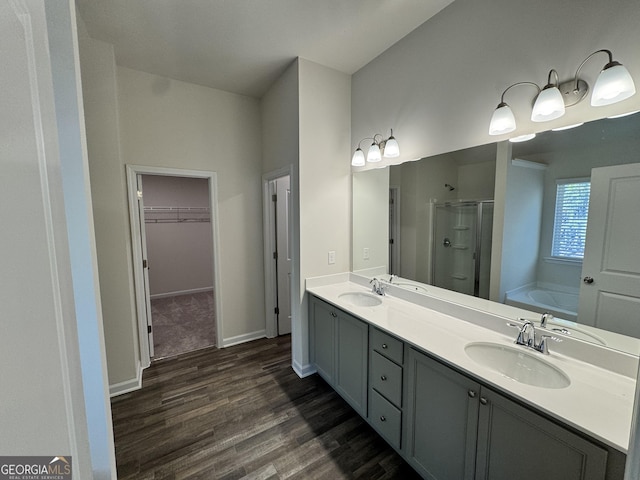 bathroom featuring hardwood / wood-style floors, vanity, and separate shower and tub