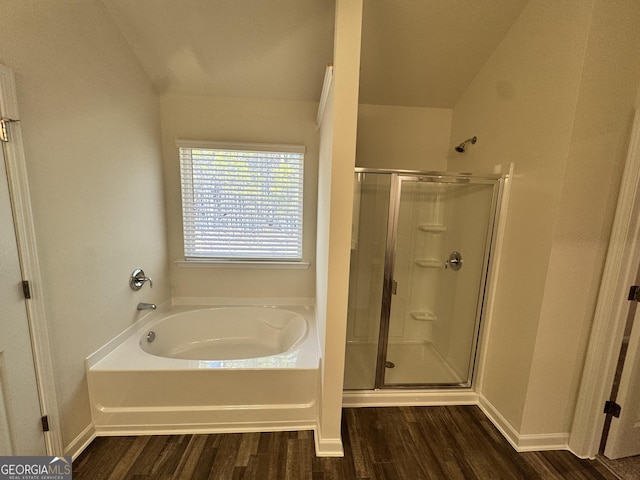 bathroom with separate shower and tub, hardwood / wood-style floors, and lofted ceiling