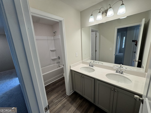 bathroom with shower / tub combination, hardwood / wood-style floors, and vanity