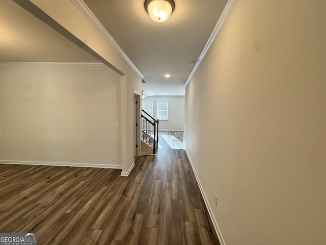 corridor featuring dark hardwood / wood-style floors and crown molding