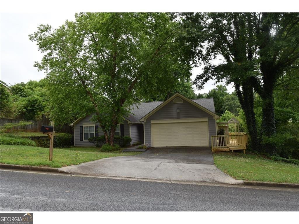 view of front of property with a garage and a front yard