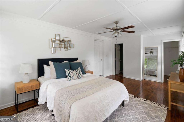 bedroom with hardwood / wood-style floors, ceiling fan, and ornamental molding