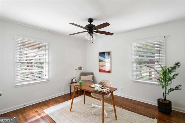 home office with dark hardwood / wood-style flooring, ceiling fan, and plenty of natural light