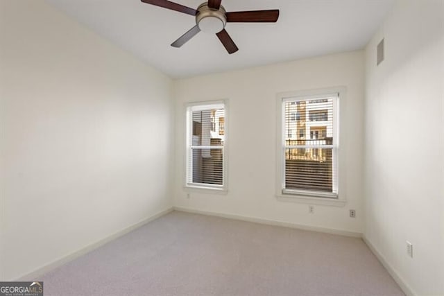 unfurnished room featuring ceiling fan and light colored carpet