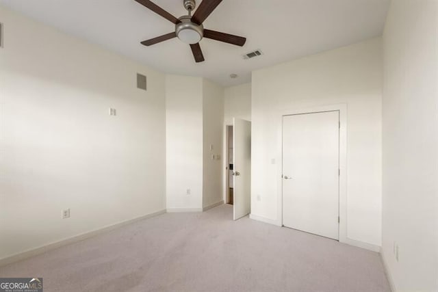 unfurnished bedroom with light colored carpet and ceiling fan