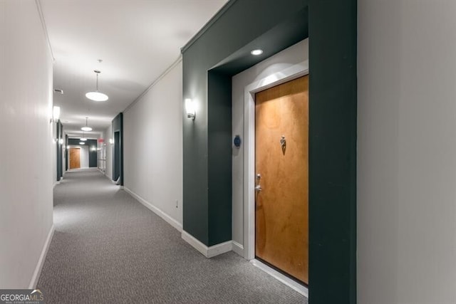 hall with light colored carpet and crown molding