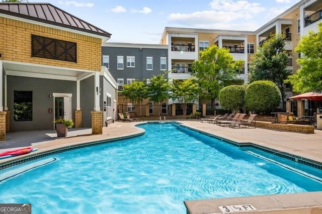 view of swimming pool featuring a patio area