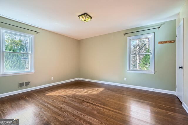 empty room with dark hardwood / wood-style floors