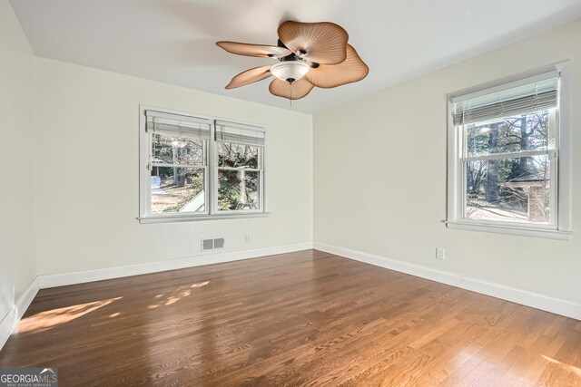 unfurnished room with dark hardwood / wood-style floors and ceiling fan