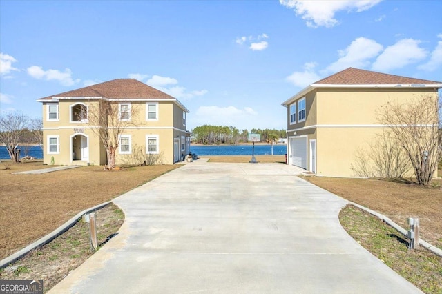 exterior space with a water view and a garage